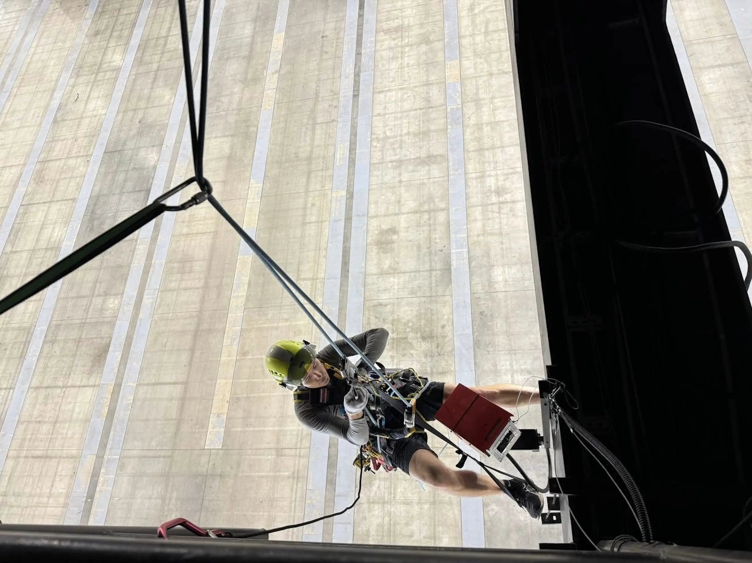 Specialist installing a construction time-lapse camera at height